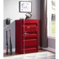 a red cabinet sitting on top of a hard wood floor