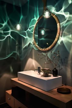 a bathroom with a sink, mirror and lights on the wall in it's corner