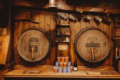 there are many barrels on the wall in this room, and one is filled with beer