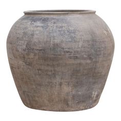 a large gray vase sitting on top of a white surface