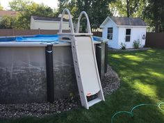 an above ground swimming pool with a slide next to it