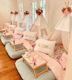 a room filled with lots of pillows and teepee tents