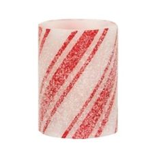 a red and white striped candle holder on a white background with glittery stripes in the center