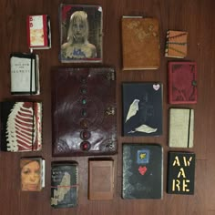 many different types of books are laid out on the table together, including one with a woman's face