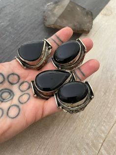 -----Price per Item----- Unique big statement rings, made with alloy metal and big Black Onyx stones. Each ring has a unique stone, so you can see there is a number that represents each ring for you to choose the one you like best. They are size adjustable, size 9 being the smallest size available, the bigger size you adjust it to, they might be a gap in the back of the ring. A most have addition to your everyday ring collection. Ring #1, #2, #3,#6 ,#7,#9, #10,#11, #14 - 1.75 inch long Ring #4, Nickel-free Black Bohemian Rings, Ring Black Stone, Big Statement Rings, Dope Jewelry Accessories, Big Stone Ring, Fall Rings, Estilo Hippy, Black Stone Ring, Big Ring