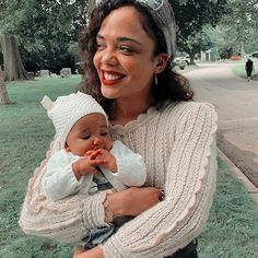 a woman holding a baby in her arms