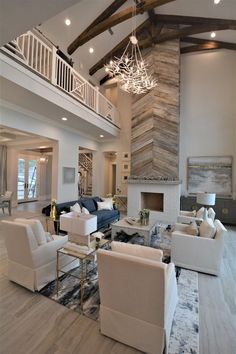 a living room filled with furniture and a fire place in the middle of a room