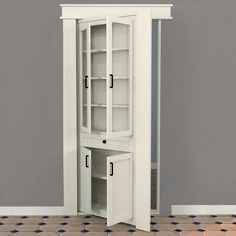 a tall white cabinet sitting in the corner of a room next to a tiled floor