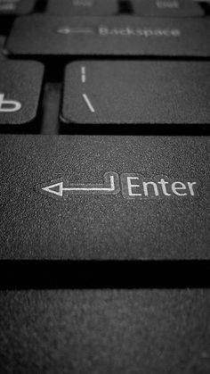 a close up of a keyboard with the word enter on it