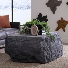 a living room with a large rock coffee table