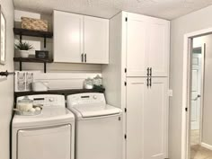 a white washer and dryer sitting in a laundry room next to each other