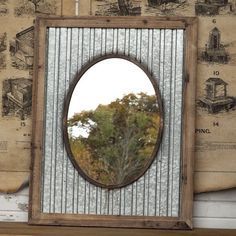 a mirror sitting on top of a wooden shelf