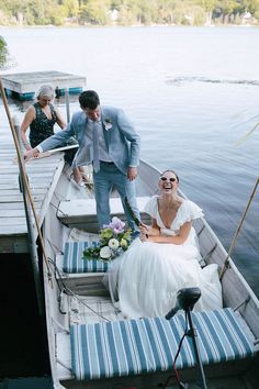 a bride and groom are sitting on a boat