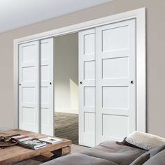 a living room filled with furniture and white doors