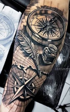 a man's arm with a compass and other items on it