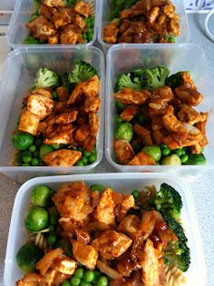 four plastic containers filled with chicken and broccoli on top of a white counter