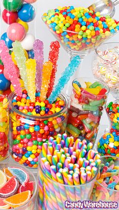 a table filled with lots of candy and lollipops