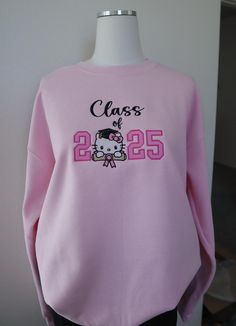 Class of 2025 Senior gradation gift, Class of  2025 Sweatshirt, Class of 2025 kitty sweater, Trendy Class 2025 Sweatshirt  pink Crewneck  8 oz., 50% Cotton/ 50% Polyester  Our sweatshirts run in unisex sizes, if between sizes or for a loose fit I recommend to size up. Make sure to choose your size accordingly! A size chart with measurements is listed, see photos. Washing Instructions: - Turn garment inside out - Hand wash or delicate was cycle - Wash in cold water - Use mild detergent - Do NOT u Senior Painted Jeans, Senior Sweatshirts, Kitty Sweater, Class Of 2025, Painted Jeans, Pink Crewneck, Pink Sweatshirt, Washing Instructions, Cold Water