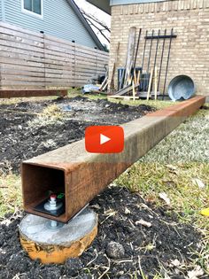 a wooden box sitting on top of a pile of dirt