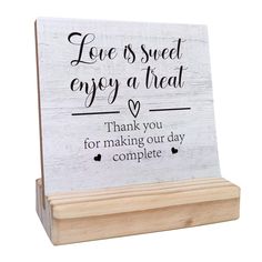 a wooden sign that says love is sweet enjoy a treat thank you for making our day complete