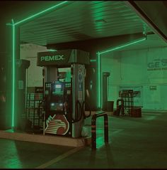 an empty gas station with neon green lights