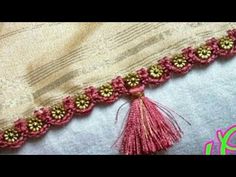 a close up of a piece of cloth with beads and tassels on it