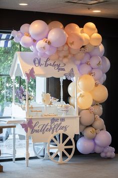 an ice cream cart with balloons attached to it