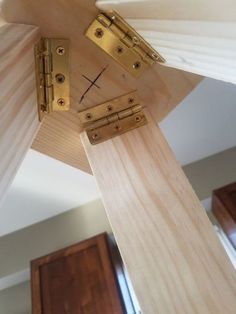 a clock made out of wood with two pieces of metal on the front and back