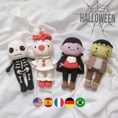 three crocheted dolls sitting next to each other on a white sheet with the words happy halloween written below them