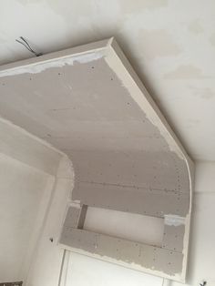 an unfinished room with white paint on the ceiling