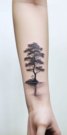 a person's arm with a tree tattoo on it