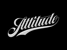 the word attitude written in white ink on a black background, with an ornate script