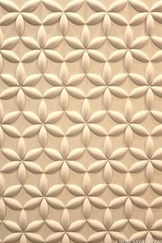 a close up view of a wall made out of white tiles with circles on it