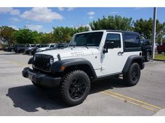 a white jeep parked in a parking lot