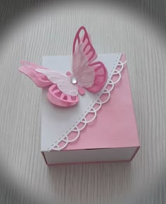 a pink and white box with a butterfly on it