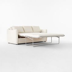 a white couch with a pull out table on it's back end, in front of a white background