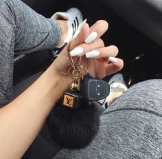 a woman is sitting in her car holding the keychain to her new car