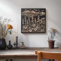 a wooden table topped with vases filled with flowers next to a painting on the wall