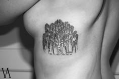 a black and white photo of a woman's chest with trees drawn on it