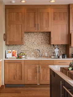 a kitchen filled with lots of wooden cabinets and counter top space next to a sink