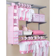 the baby's closet is organized with pink and white items