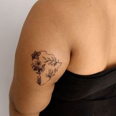 a woman with a flower tattoo on her arm