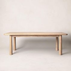 a wooden table sitting on top of a white floor