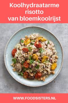 a bowl filled with rice and vegetables on top of a table