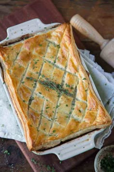 a pie sitting on top of a wooden cutting board