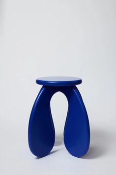 a blue stool sitting on top of a white floor