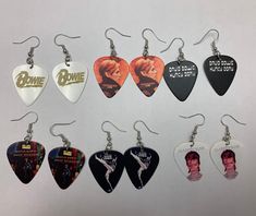 six guitar picks are hanging from hooks