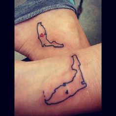 two small tattoos on the wrist that are both in black and white, one with a map