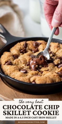 chocolate chip skillet cookie in a cast iron skillet with text overlay that reads the very best chocolate chip skillet cookie