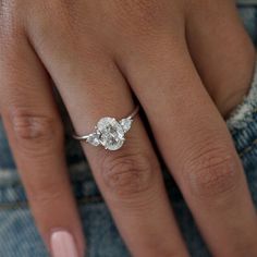 a woman's hand with a diamond ring on it